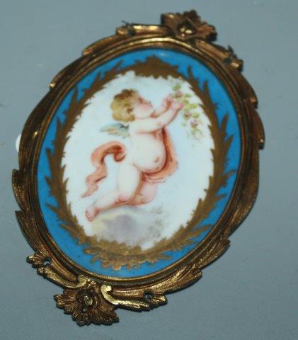 Sevres style porcelain oval plaque in ormolu mount